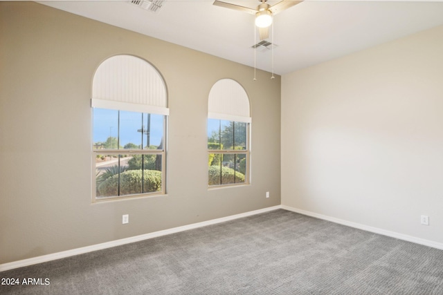 unfurnished room with ceiling fan and carpet flooring