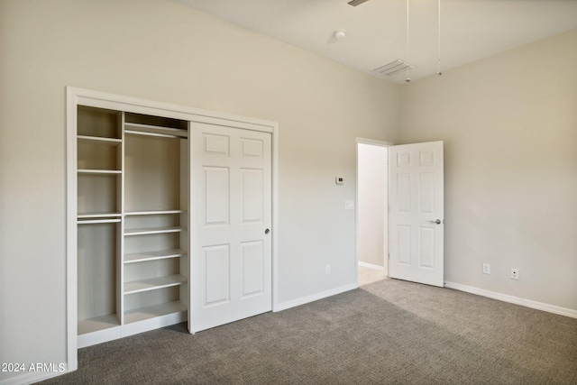 unfurnished bedroom featuring a closet and carpet floors