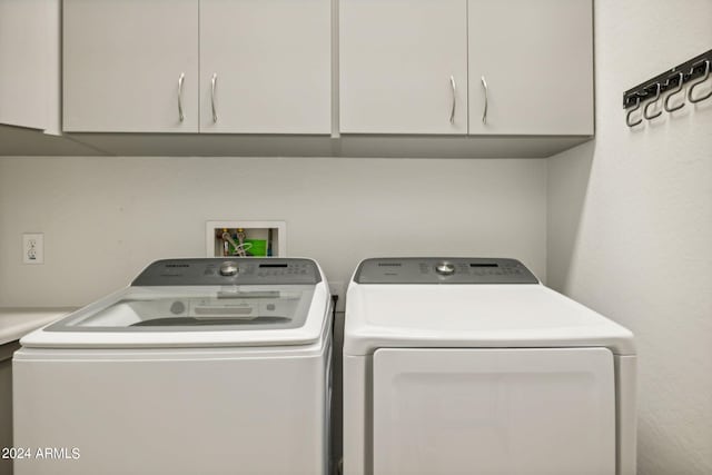 laundry area featuring cabinets and washer and clothes dryer