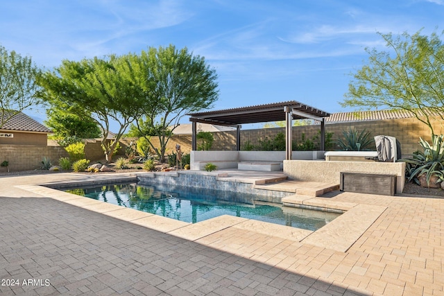 view of pool with a pergola, a patio area, and an outdoor kitchen