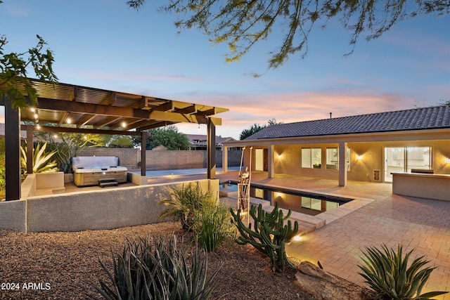 patio terrace at dusk featuring a grill, a pergola, a hot tub, and area for grilling