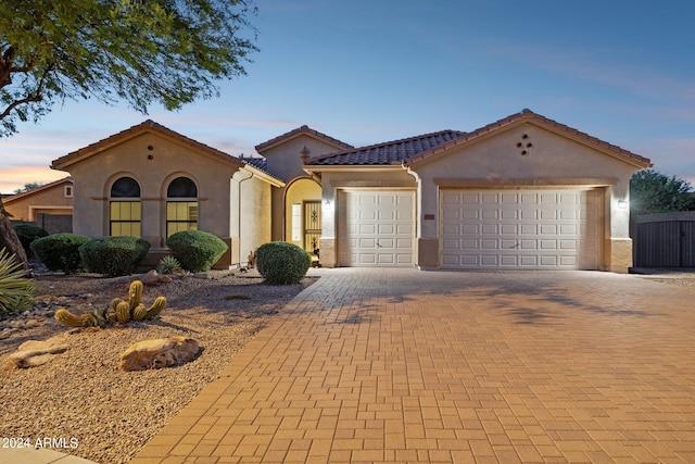 mediterranean / spanish-style home with a garage