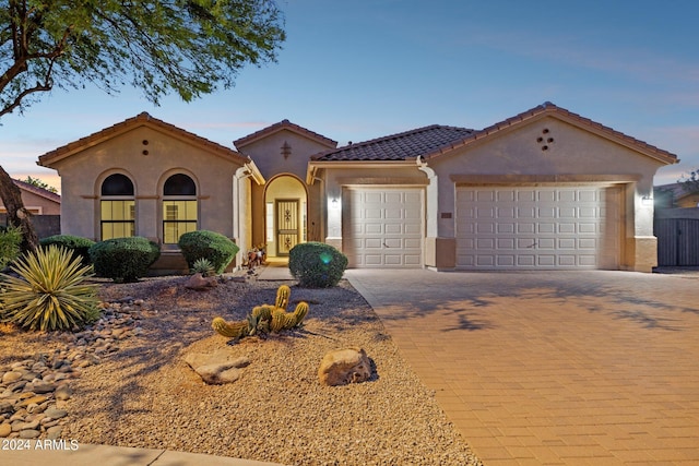 mediterranean / spanish-style home with a garage