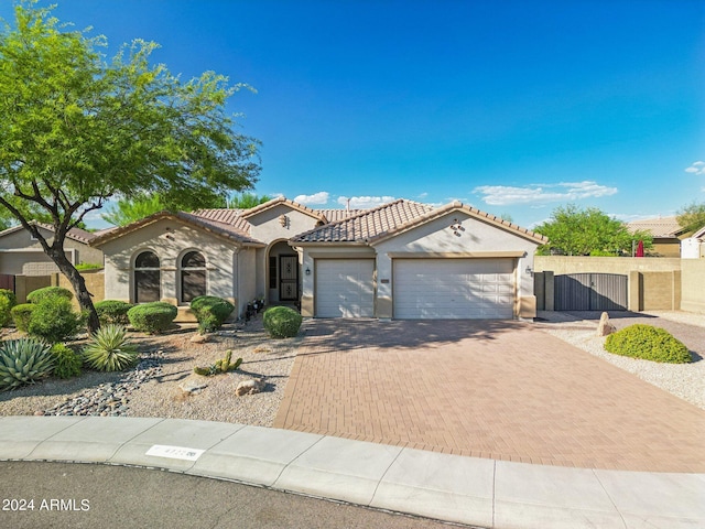 mediterranean / spanish-style home featuring a garage