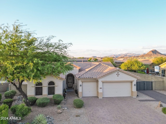 view of front of property with a garage and a mountain view