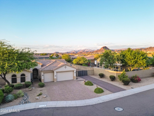 view of front of house with a garage and a mountain view