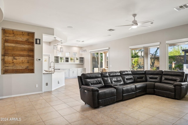 tiled living room with ceiling fan