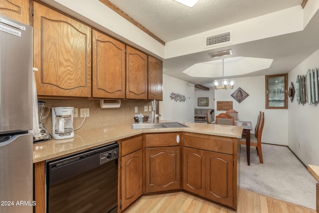 kitchen with black dishwasher, kitchen peninsula, light hardwood / wood-style floors, and stainless steel fridge