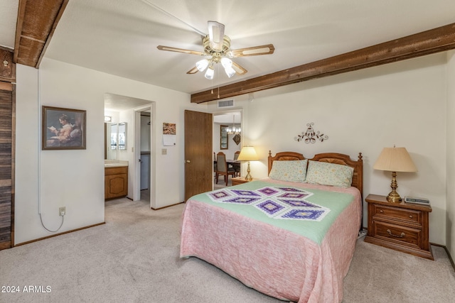 bedroom featuring ensuite bath, light carpet, and ceiling fan