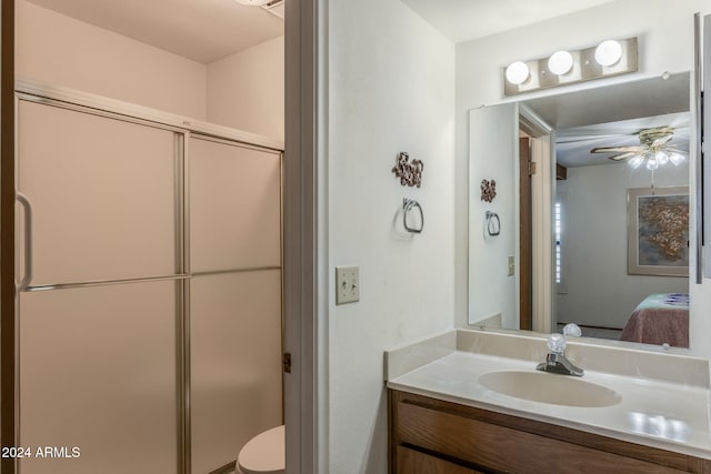 bathroom with vanity, ceiling fan, and toilet