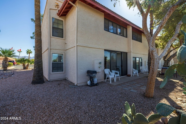 rear view of property featuring a patio area