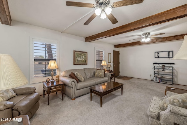 living room with ceiling fan, light colored carpet, and beamed ceiling