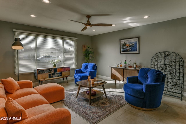 living area with baseboards, ceiling fan, tile patterned floors, and recessed lighting