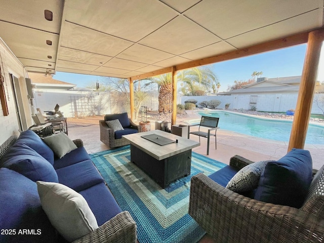 view of patio with a fenced in pool, an outdoor living space with a fire pit, and a fenced backyard