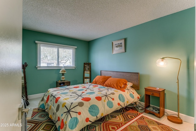 bedroom featuring baseboards and a textured ceiling