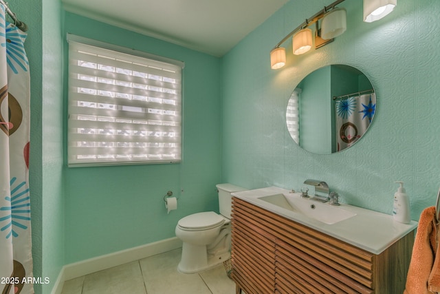 bathroom featuring vanity, tile patterned flooring, toilet, and baseboards