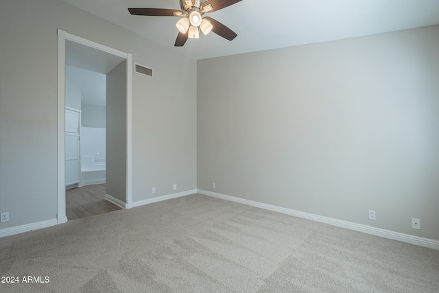 empty room featuring light carpet and ceiling fan