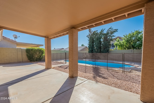 view of patio with a fenced in pool