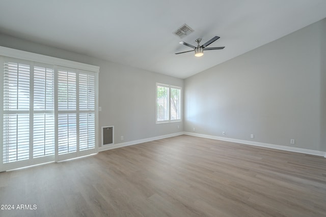 empty room with light hardwood / wood-style floors, ceiling fan, and lofted ceiling