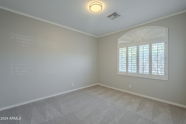 carpeted empty room featuring ornamental molding