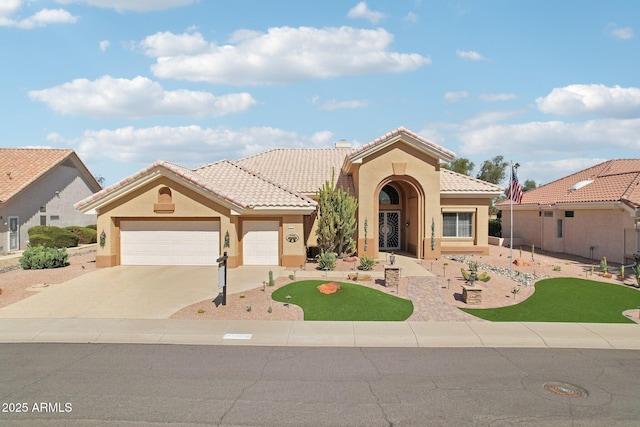 mediterranean / spanish house featuring a tiled roof, an attached garage, driveway, and stucco siding