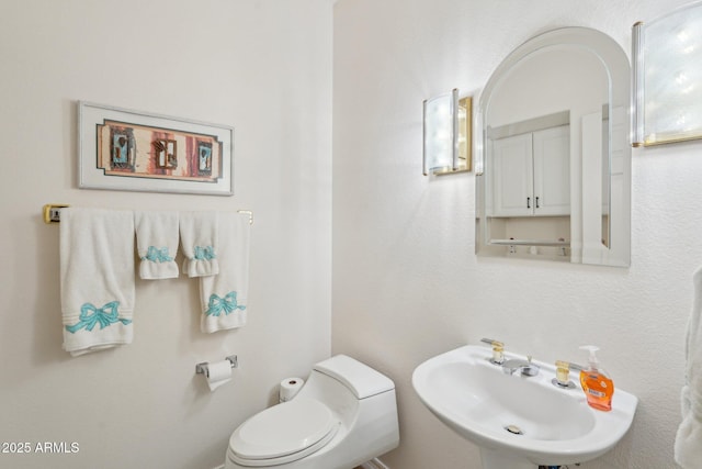 bathroom featuring toilet and a sink