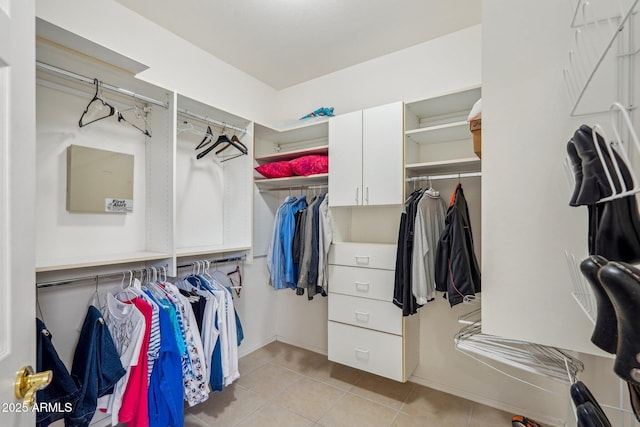 spacious closet with light tile patterned floors