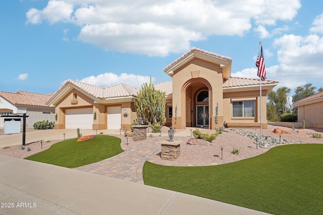 mediterranean / spanish-style house featuring a tiled roof, an attached garage, driveway, and stucco siding