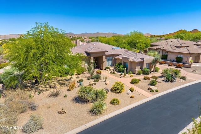 9534 E Monument Dr, Scottsdale, AZ 85262 - view of front of home with a tile roof, stucco siding, a mountain view, and a chimney