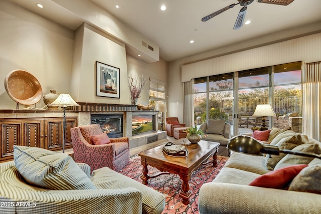 9534 E Monument Dr, Scottsdale, AZ 85262 - living area featuring recessed lighting, a glass covered fireplace, and a ceiling fan
