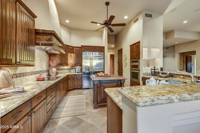 9534 E Monument Dr, Scottsdale, AZ 85262 - kitchen with stainless steel appliances, backsplash, a ceiling fan, light stone counters, and recessed lighting
