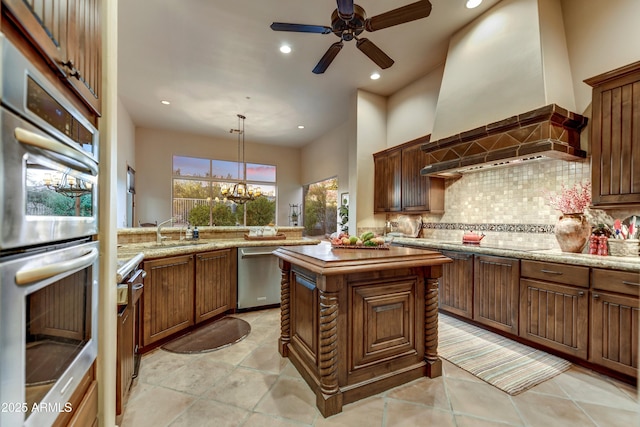 9534 E Monument Dr, Scottsdale, AZ 85262 - kitchen featuring appliances with stainless steel finishes, backsplash, a sink, a ceiling fan, and wall chimney exhaust hood