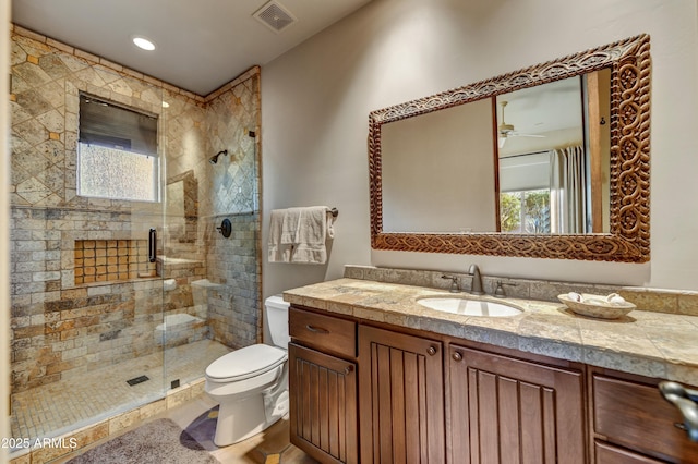 9534 E Monument Dr, Scottsdale, AZ 85262 - bathroom featuring toilet, a stall shower, vanity, and a ceiling fan
