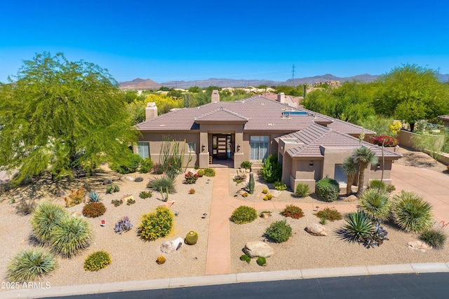 9534 E Monument Dr, Scottsdale, AZ 85262 - prairie-style home featuring a tiled roof, stucco siding, a chimney, and a mountain view