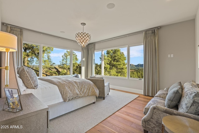 bedroom with wood-type flooring and baseboards