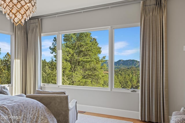 bedroom featuring baseboards and wood finished floors