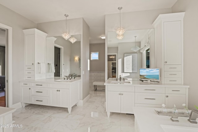 full bathroom with marble finish floor, two vanities, and a sink