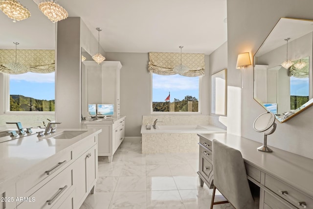 bathroom featuring a bath, marble finish floor, two vanities, and a sink