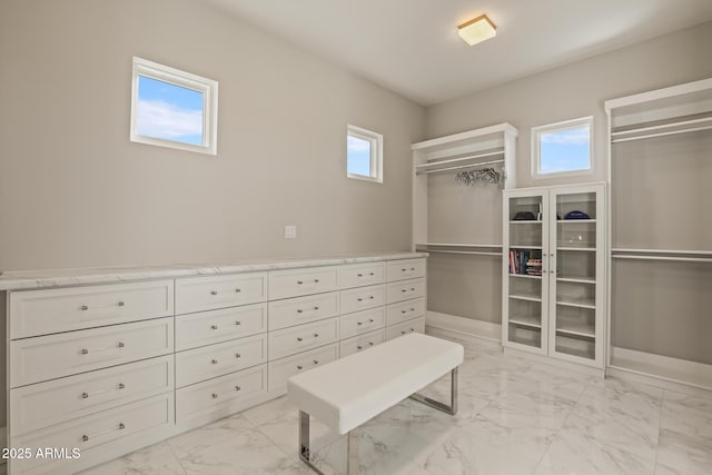 spacious closet with marble finish floor