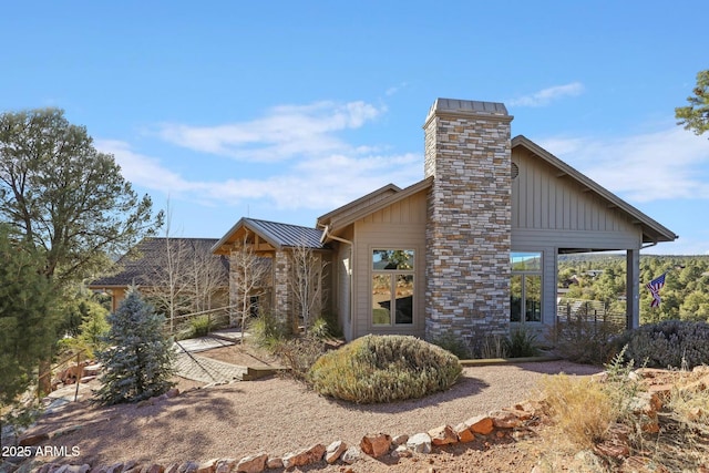 view of property exterior with metal roof, a standing seam roof, and board and batten siding