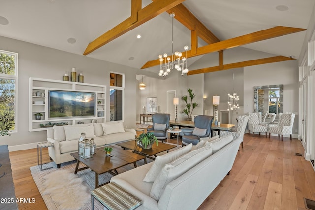 living area with high vaulted ceiling, a wealth of natural light, a chandelier, beamed ceiling, and hardwood / wood-style flooring