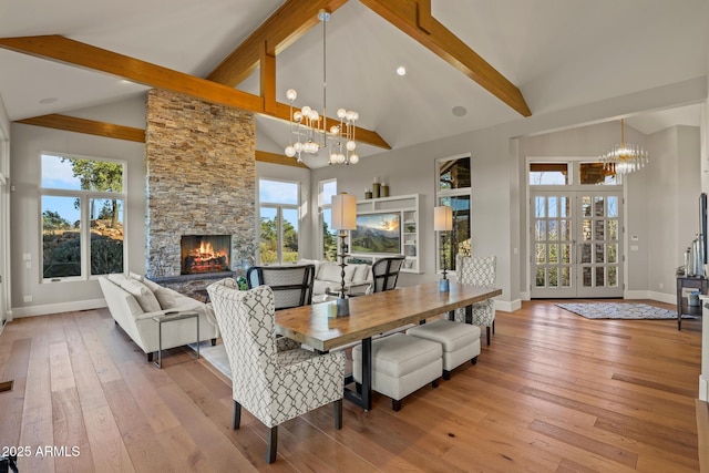 dining area with light wood-style floors, plenty of natural light, and a chandelier