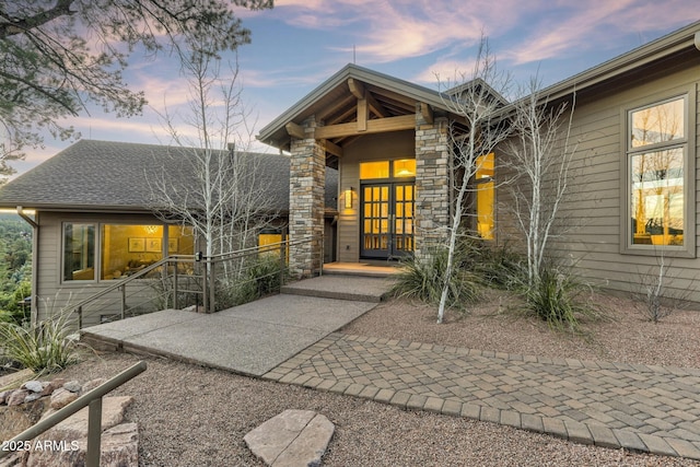 exterior space featuring a shingled roof