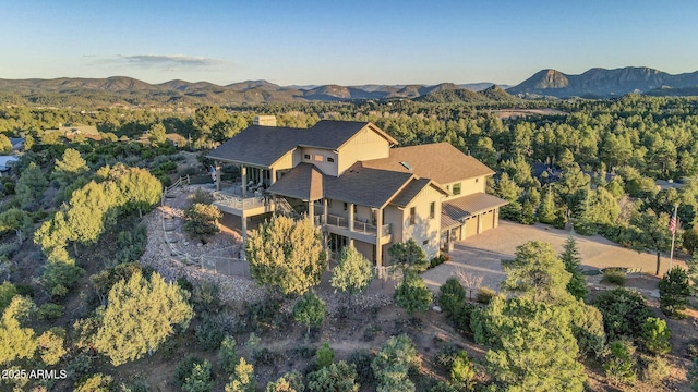 birds eye view of property with a mountain view and a view of trees