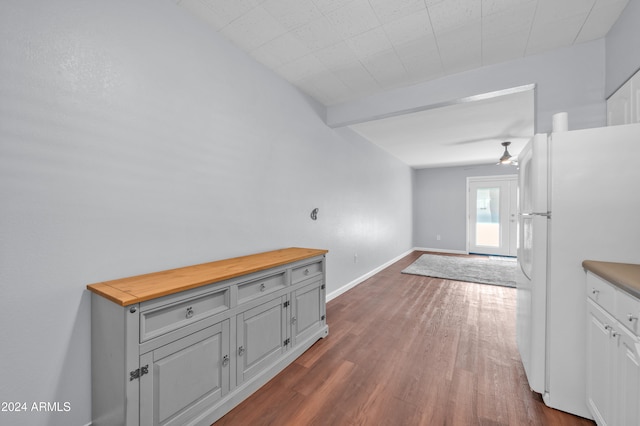 interior space with butcher block countertops, ceiling fan, white fridge, and dark hardwood / wood-style floors