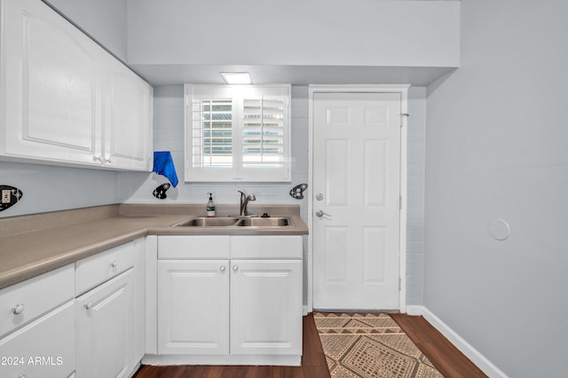 kitchen featuring white cabinetry, dark wood-type flooring, and sink