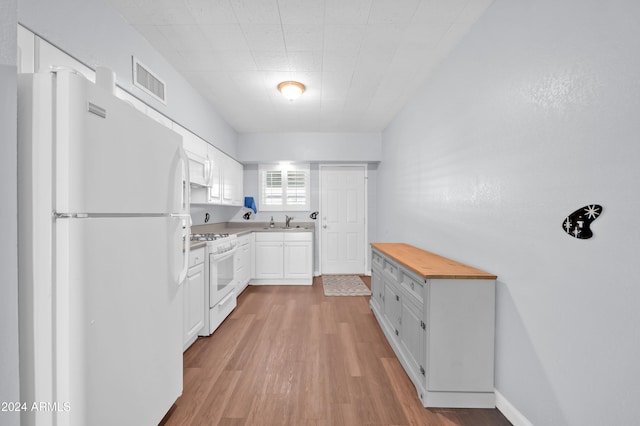 kitchen with wooden counters, white cabinetry, light wood-type flooring, sink, and white appliances