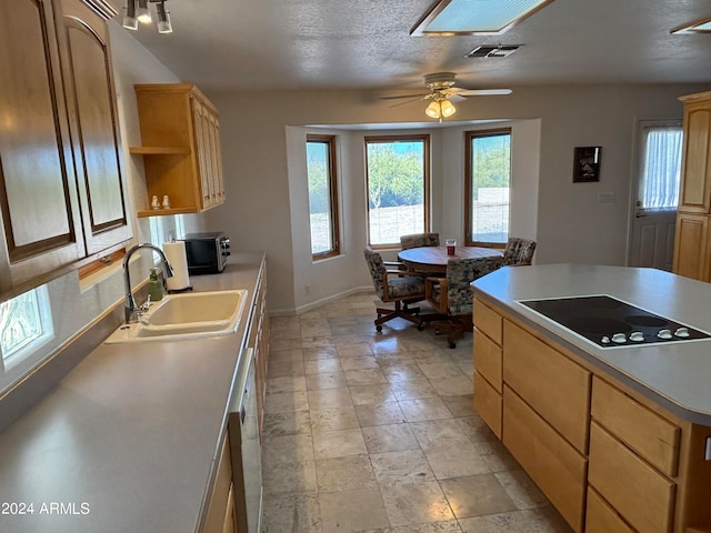 kitchen with electric stovetop, a wealth of natural light, light tile floors, sink, and ceiling fan