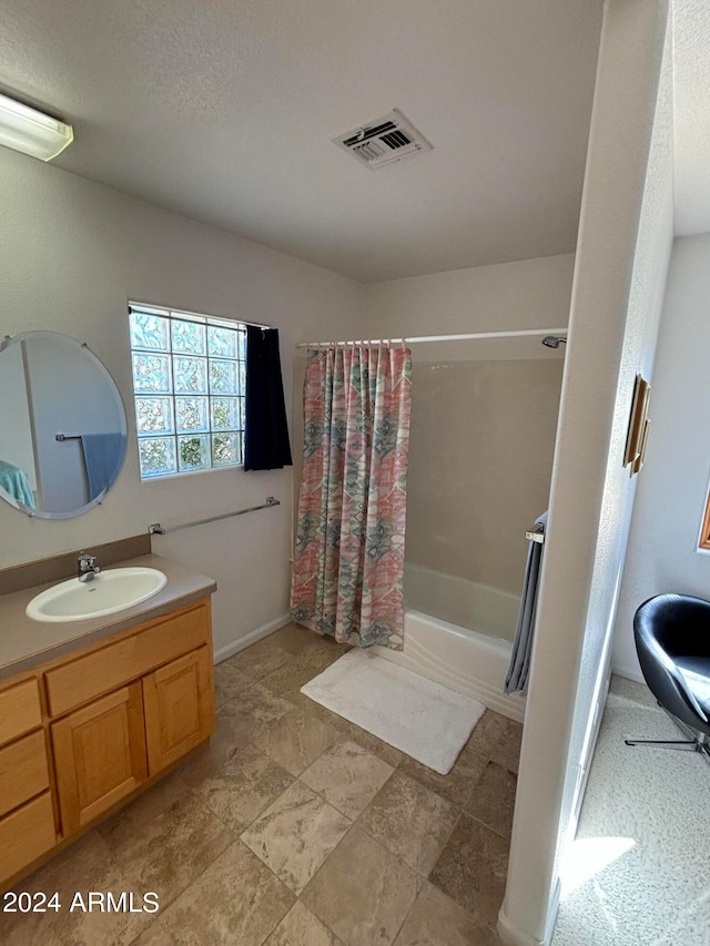 bathroom with vanity, tile floors, and a textured ceiling