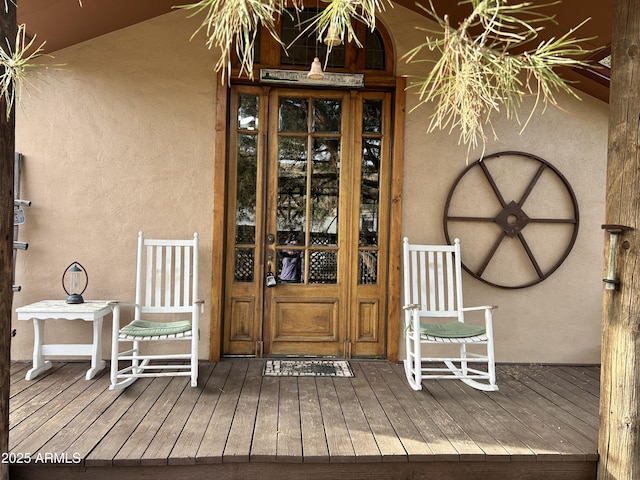 view of exterior entry featuring a porch